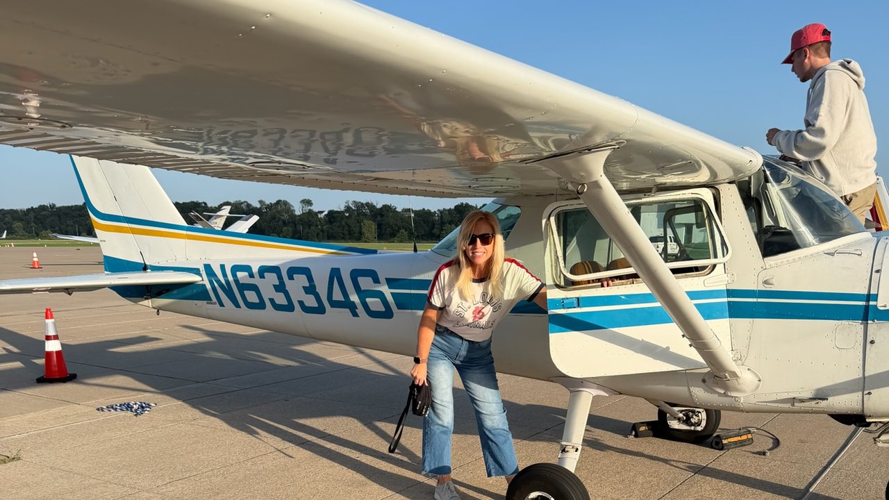 Passenger beside Cessna 150 N63346 during preflight, with Carter at the wing